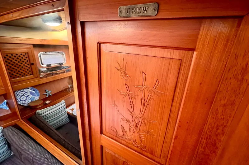 Slide: The Image of Interior of 1985 Heritage East 40 Sundeck, featuring wooden paneling and nautical decor. - 26