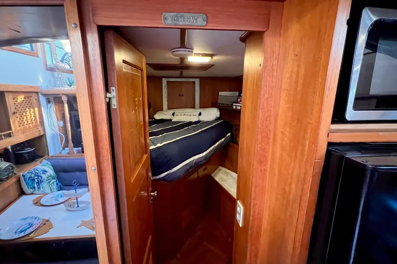 Slide: The Image of 1985 Heritage East 40 Sundeck interior with cozy aft cabin and dining area. - 27
