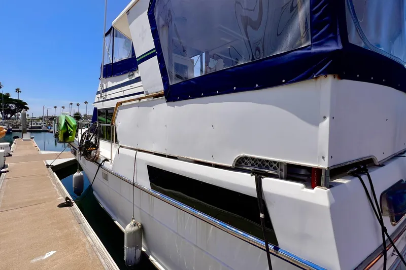 Slide: The Image of 1985 Heritage East 40 Sundeck Trawler docked at marina under clear blue sky. - 3