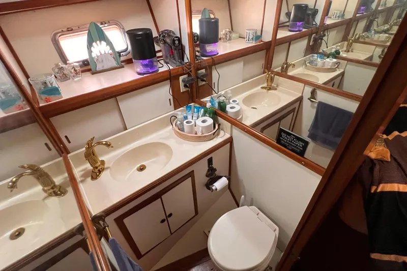 Slide: The Image of 1985 Heritage East 40 Sundeck bathroom with dual sinks, mirrors, and gold fixtures. - 30