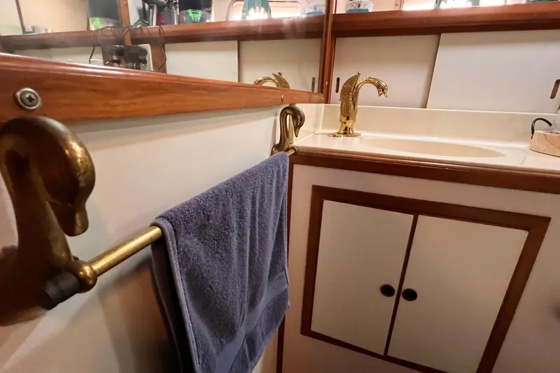 Slide: The Image of 1985 Heritage East 40 Sundeck bathroom with brass fixtures and wooden accents. - 31