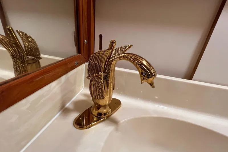Slide: The Image of Golden swan-shaped faucet in 1985 Heritage East 40 Sundeck yacht bathroom. - 32