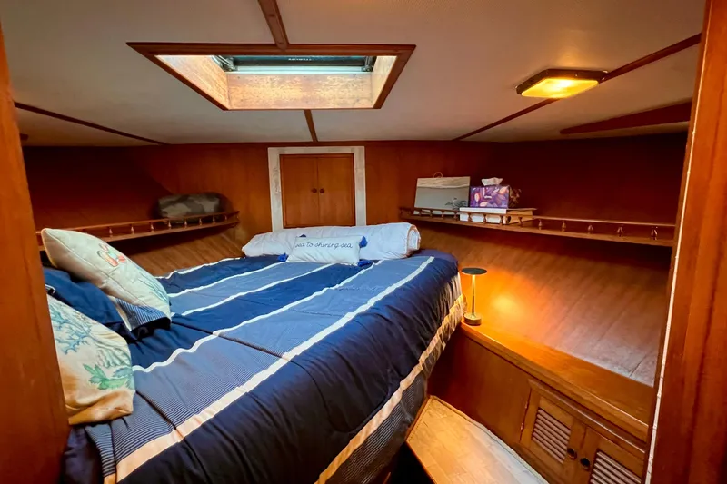 Slide: The Image of Cozy cabin interior of 1985 Heritage East 40 Sundeck Trawler with skylight and bedding. - 38