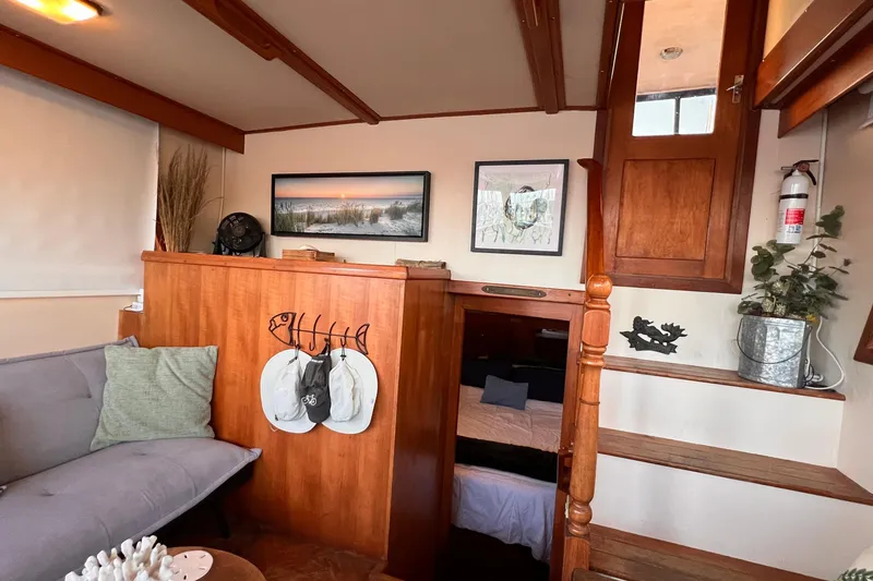 Slide: The Image of Interior of 1985 Heritage East 40 Sundeck Trawler with cozy seating and wooden accents. - 41