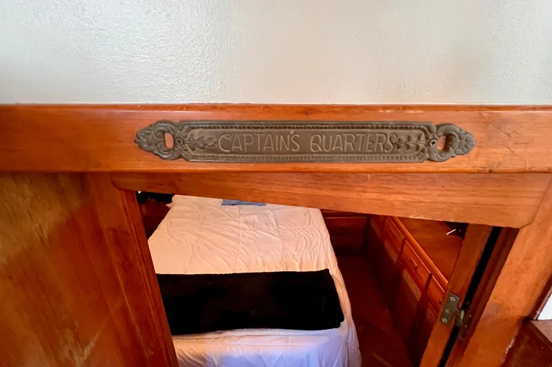 Slide: The Image of Captain's quarters entrance in 1985 Heritage East 40 Sundeck trawler, featuring wooden interior. - 43