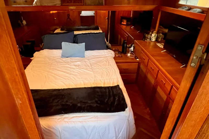 Slide: The Image of Cozy bedroom in 1985 Heritage East 40 Sundeck trawler with wood furnishings and double bed. - 44