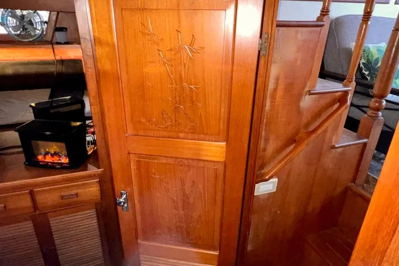 Slide: The Image of 1985 Heritage East 40 Sundeck interior with carved wooden door and cozy cabin features. - 47