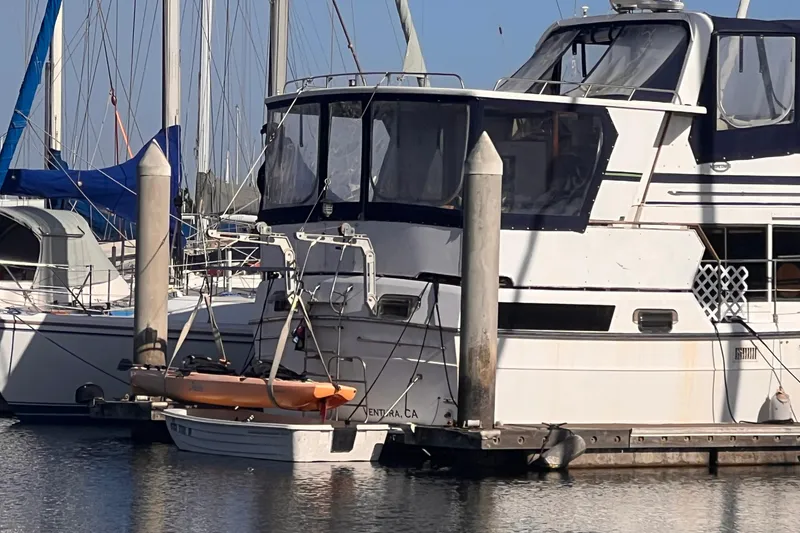 Slide: The Image of 1985 Heritage East 40 Sundeck Trawler docked at marina with kayak. - 5