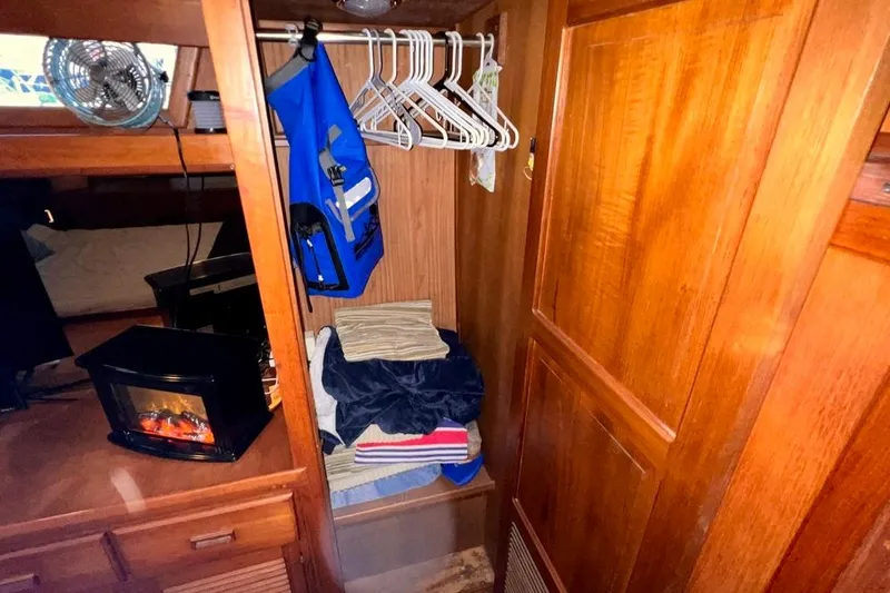 Slide: The Image of Cozy cabin interior of 1985 Heritage East 40 Sundeck with wood paneling and storage. - 52