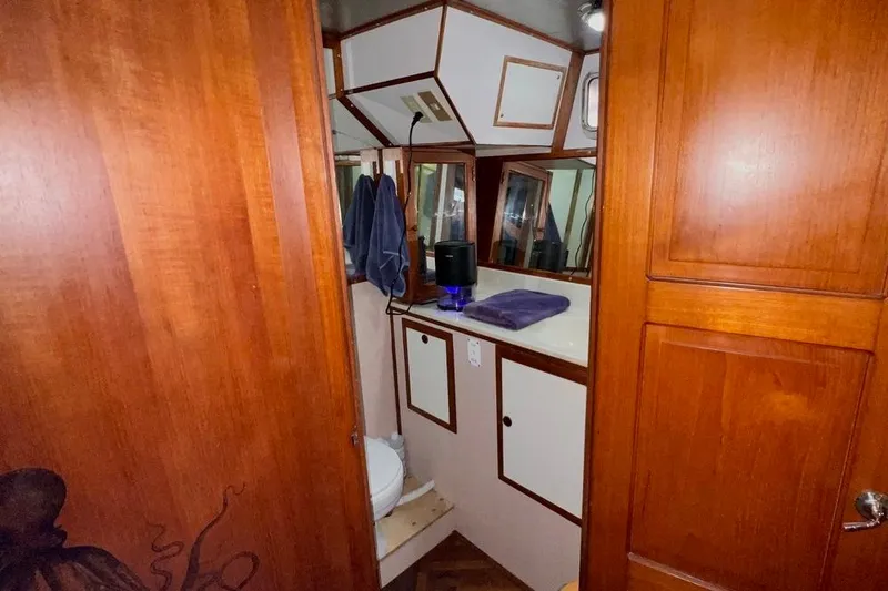 Slide: The Image of 1985 Heritage East 40 Sundeck bathroom with wooden cabinetry and mirrors. - 55
