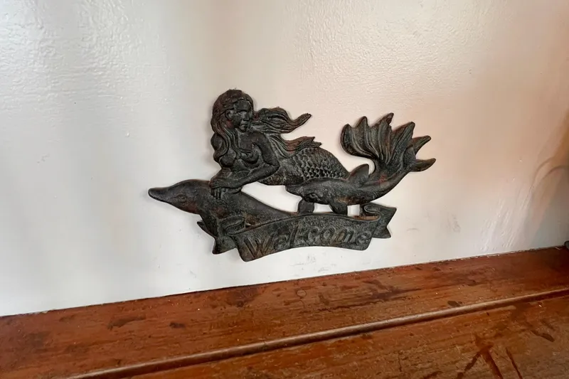 Slide: The Image of Decorative mermaid welcome plaque on 1985 Heritage East 40 Sundeck trawler interior. - 59