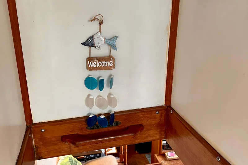 Slide: The Image of Welcome sign with fish decor inside 1985 Heritage East 40 Sundeck trawler. - 60