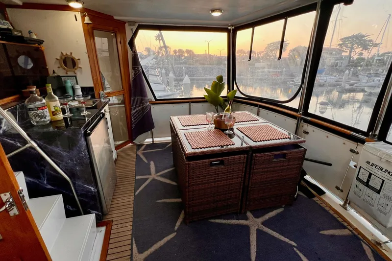 Slide: The Image of Interior of 1985 Heritage East 40 Sundeck Trawler with dining area and marina view. - 61