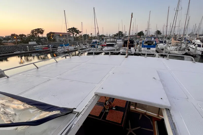 Slide: The Image of 1985 Heritage East 40 Sundeck Trawler docked at marina during sunset. - 62