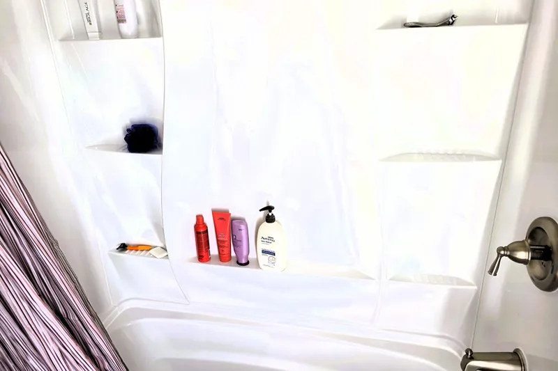 Slide: The Image of Shower with toiletries and striped curtain on Bluewater Yachts 5900 Coastal Cruiser, 1991 model. - 20