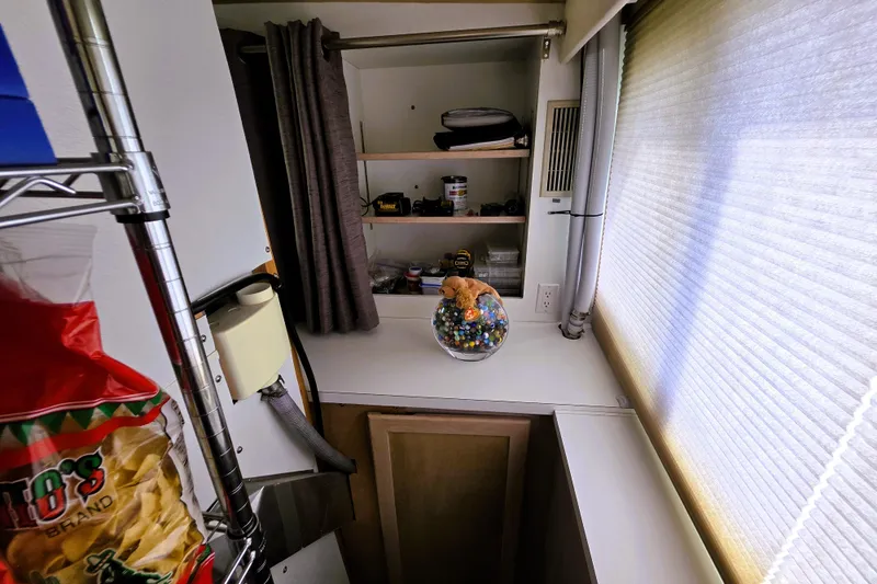 Slide: The Image of Interior of 1991 Bluewater Yachts 5900 Coastal Cruiser with shelves and decorative items. - 26