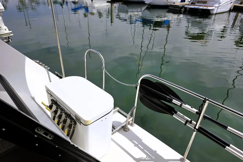 Slide: The Image of 1991 Bluewater Yachts 5900 Coastal Cruiser docked, featuring deck equipment and calm marina waters. - 35