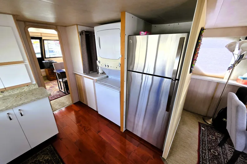 Slide: The Image of Interior of 1991 Bluewater Yachts 5900 Coastal Cruiser with kitchen and appliances. - 5