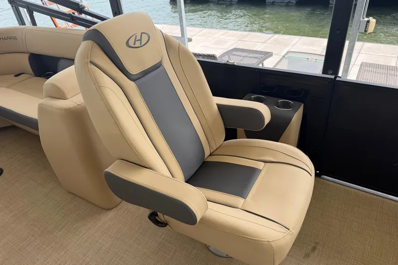 Slide: The Image of Luxurious seating on 2023 Harris Cruiser 250 CW boat, featuring beige and gray upholstery. - 10