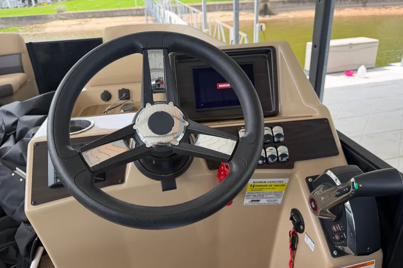 Slide: The Image of 2023 Harris Cruiser 250 CW boat dashboard with steering wheel and controls. - 12
