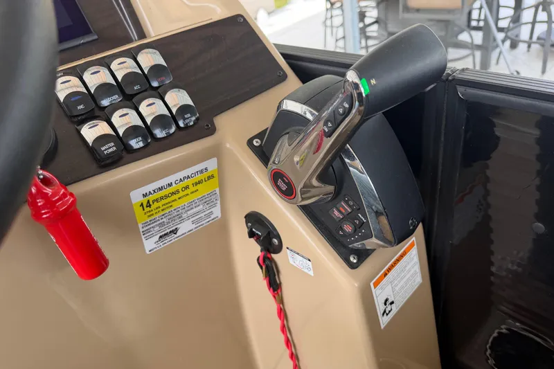 Slide: The Image of Control panel of 2023 Harris Cruiser 250 CW boat, featuring switches and throttle. - 13