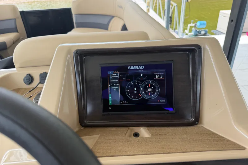 Slide: The Image of Simrad display on 2023 Harris Cruiser 250 CW boat dashboard, showing navigation data. - 16