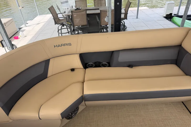 Slide: The Image of 2023 Harris Cruiser 250 CW boat interior with beige and gray seating. - 19