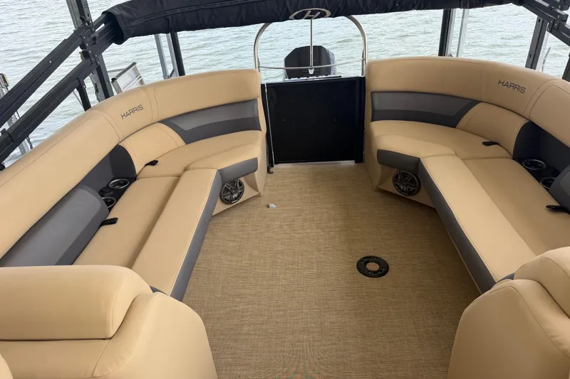 Slide: The Image of 2023 Harris Cruiser 250 CW interior with beige seating and lake view. - 9