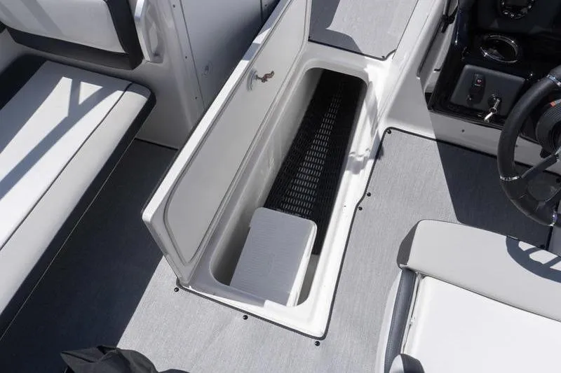 Slide: The Image of 2026 Yamaha Boats AR195 interior storage compartment with seating and steering wheel visible. - 11