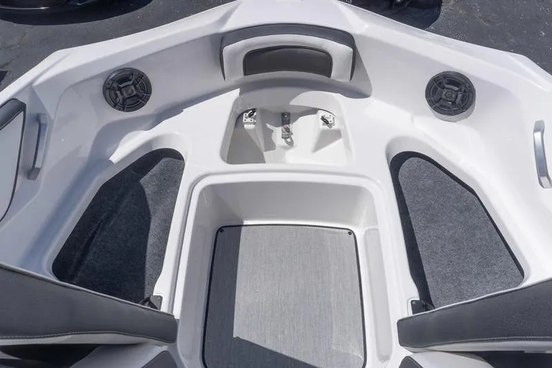 Slide: The Image of 2026 Yamaha Boats AR195 bow seating area with speakers and storage. - 13