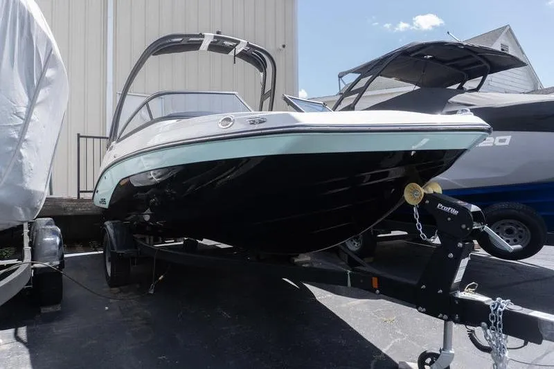 Slide: The Image of 2026 Yamaha Boats AR195 on trailer, parked outdoors under clear sky. - 2