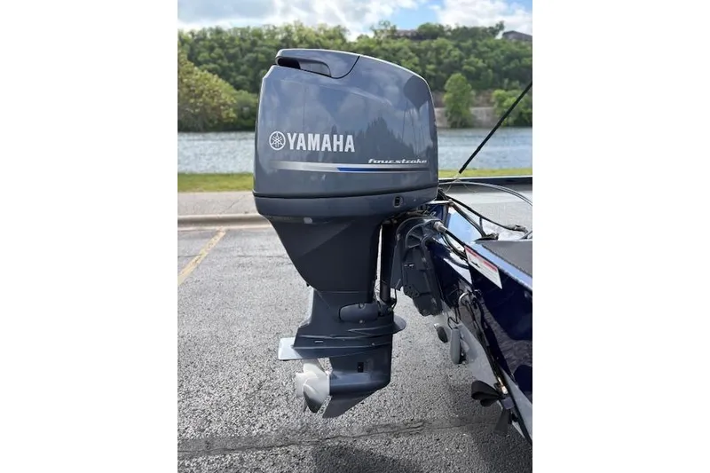 Slide: The Image of 2017 G3 Sportsman 1710 Vinyl with Yamaha four-stroke outboard motor by a lake. - 12