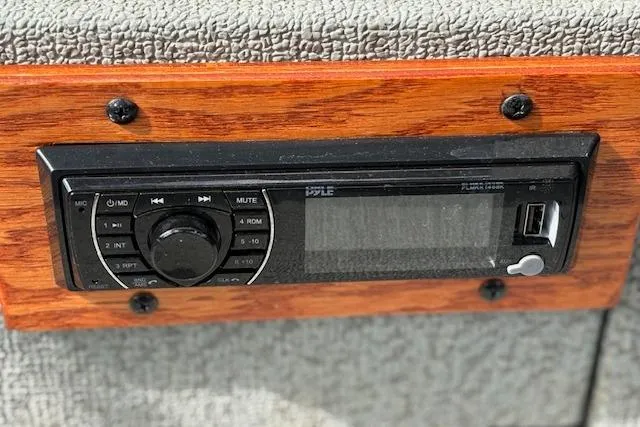 Slide: The Image of 2017 G3 Sportsman 1710 Vinyl boat stereo system with USB port on wooden panel. - 20
