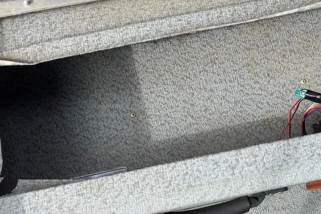 Slide: The Image of 2017 G3 Sportsman 1710 Vinyl boat interior with gray carpet and visible wiring. - 24