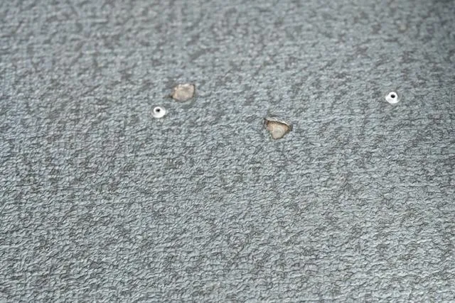 Slide: The Image of 2017 G3 Sportsman 1710 Vinyl flooring with visible wear and tear. - 25