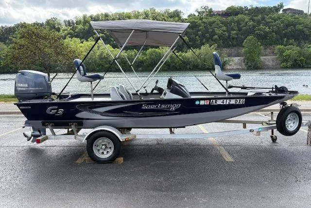 Slide: The Image of 2017 G3 Sportsman 1710 Vinyl boat on trailer by a river, featuring a canopy and Yamaha motor. - 3