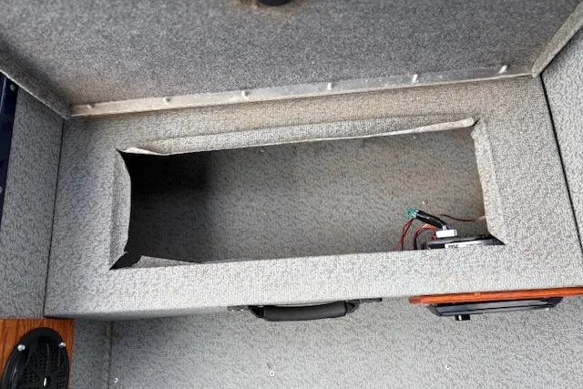 Slide: The Image of 2017 G3 Sportsman 1710 Vinyl boat interior storage compartment with wiring visible. - 31
