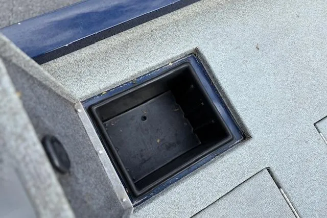 Slide: The Image of 2017 G3 Sportsman 1710 Vinyl boat storage compartment with gray carpeted interior. - 35
