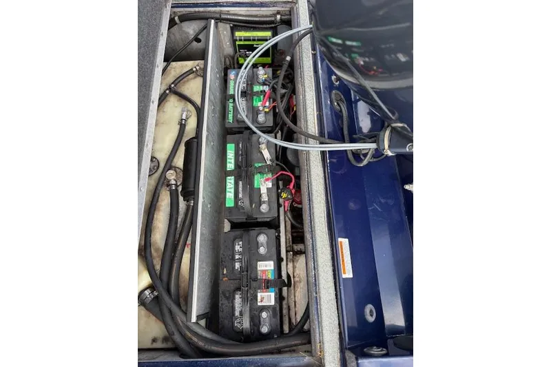 Slide: The Image of 2017 G3 Sportsman 1710 Vinyl boat battery compartment with wiring and connections. - 38