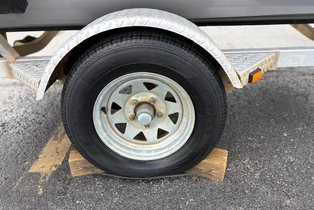 Slide: The Image of Trailer wheel of 2017 G3 Sportsman 1710 Vinyl, secured with wooden chocks. - 42