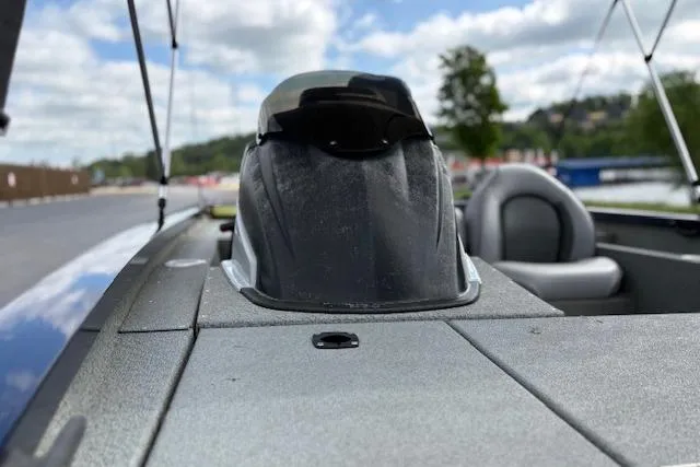 Slide: The Image of 2017 G3 Sportsman 1710 Vinyl boat interior with seating and console, under a partly cloudy sky. - 52