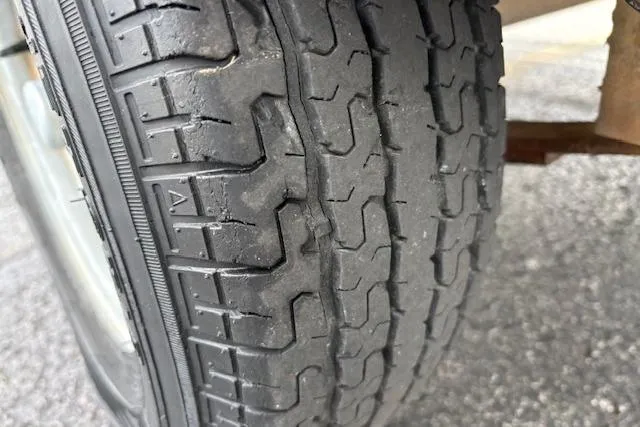 Slide: The Image of Worn tire tread on a 2017 G3 Sportsman 1710 Vinyl, showing significant wear and tear. - 53
