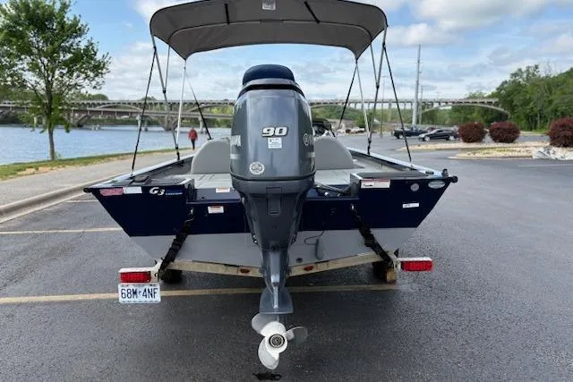 Slide: The Image of 2017 G3 Sportsman 1710 Vinyl boat with 90 HP engine, parked near a scenic river. - 9