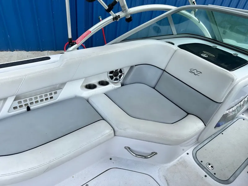 Slide: The Image of Interior of a 2007 Nautique 211 boat with gray upholstery. - 11