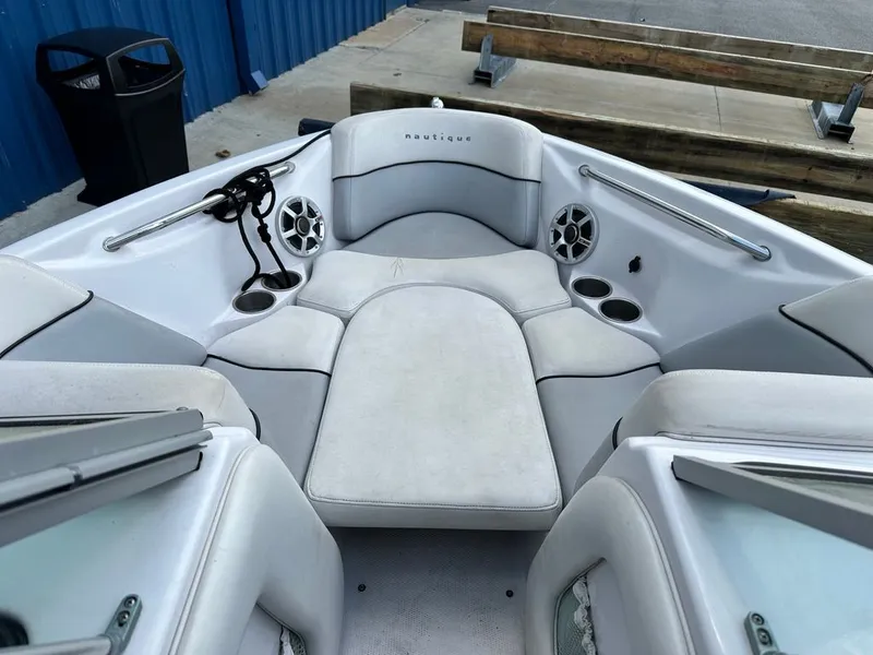 Slide: The Image of Interior of a 2007 Nautique 211 boat with seating and speakers. - 13