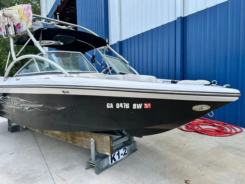 Slide: The Image of 2007 Nautique 211 boat on a dock in front of blue wall. - 19
