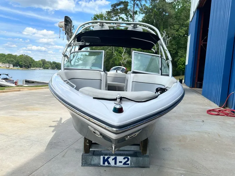 Slide: The Image of 2007 Nautique 211 boat docked with lake view. - 20