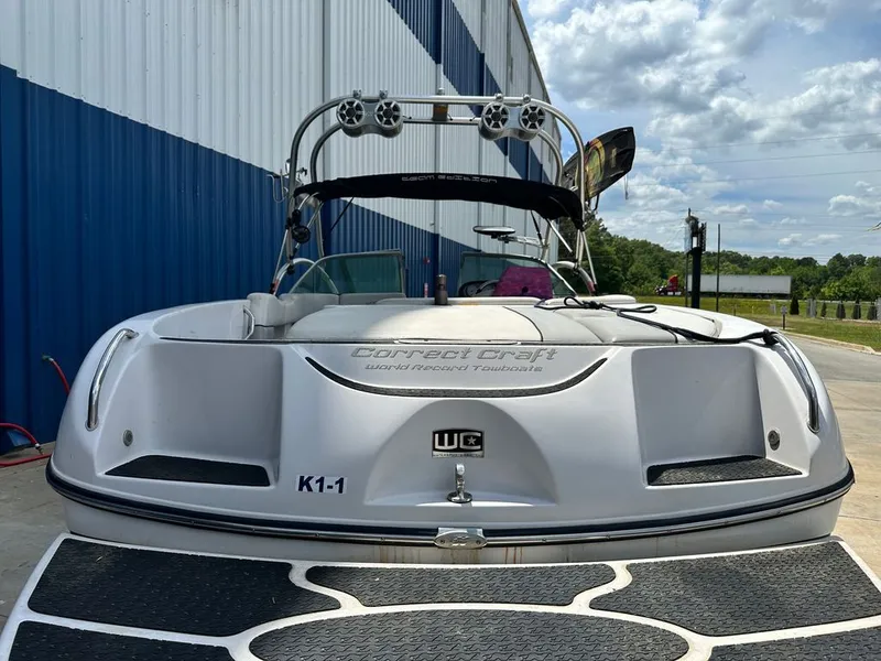 Slide: The Image of 2007 Nautique 211 boat in front of warehouse, blue sky. - 22