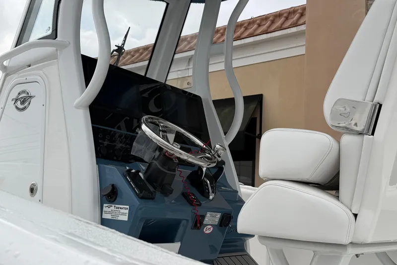 Slide: The Image of 2026 Tidewater 272 LXF boat cockpit with steering wheel and seating. - 3