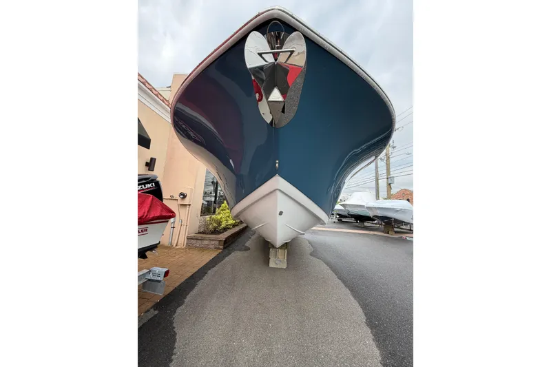 Slide: The Image of 2026 Tidewater 272 LXF boat with sleek blue hull, displayed outdoors. - 5